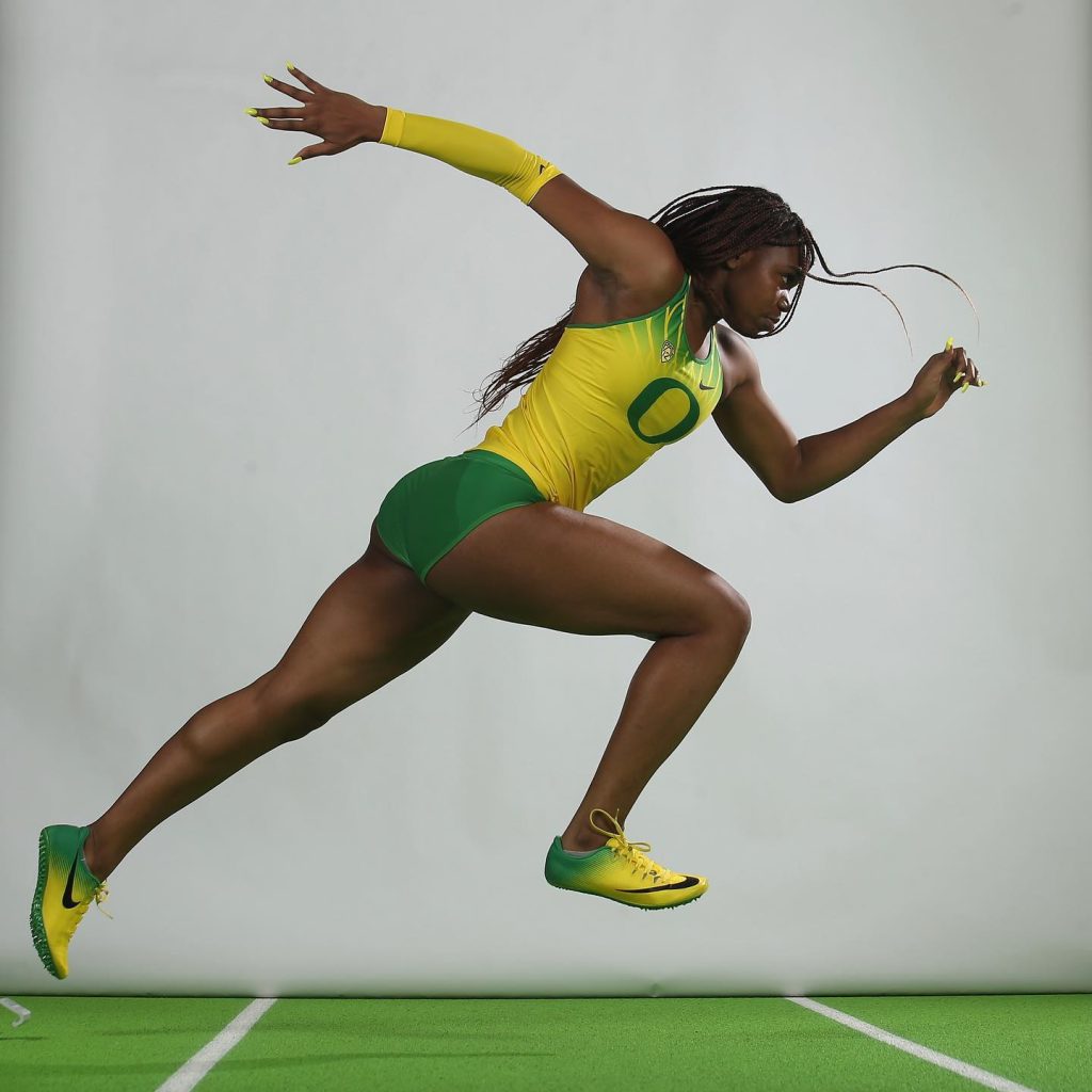 Colleen, in mid-sprint, in her Oregon Ducks track uniform.