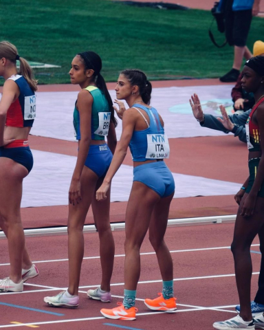 Italian sprinter Margherita Castellani awaits the baton