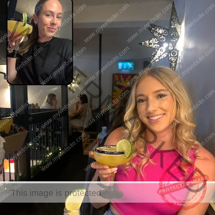 Sarah McCarthy wearing a pink dress and sitting with a margarita in her hand,