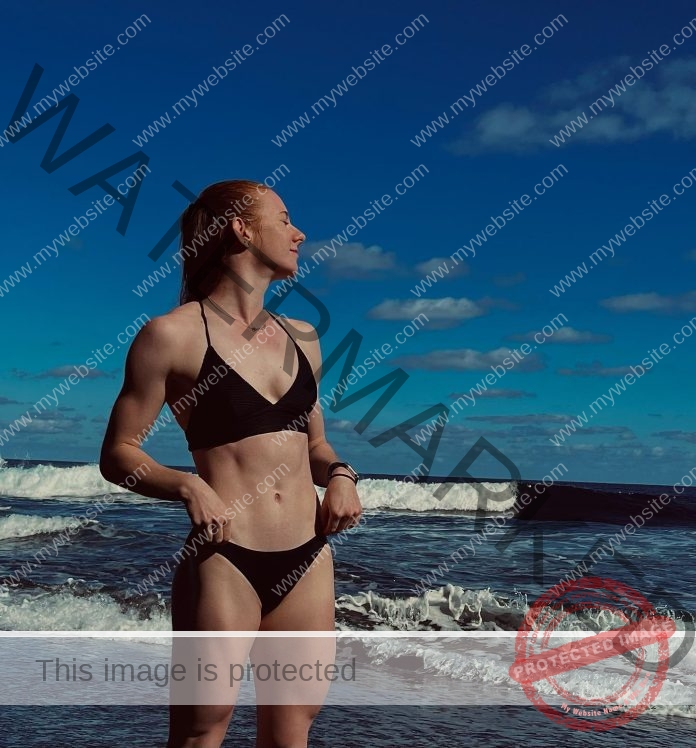 Sarah Michelle Kudla in a black bikini on the beach