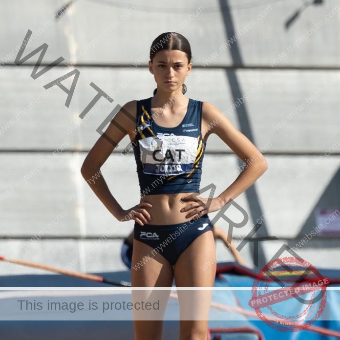 Adriana Curto standing at the ready in her track uniform, on the track.