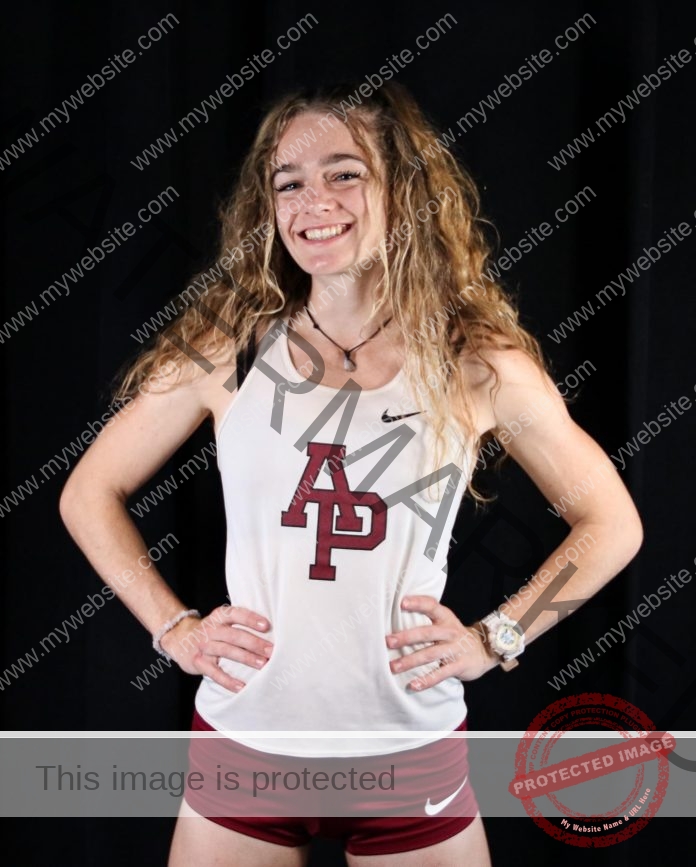 Olivia Baerny posing for media day pictures in her Azusa Pacific track uniform