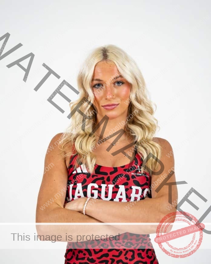 Paige Laffoon in her college track uniform, standing arms folded ion a photo shoot.