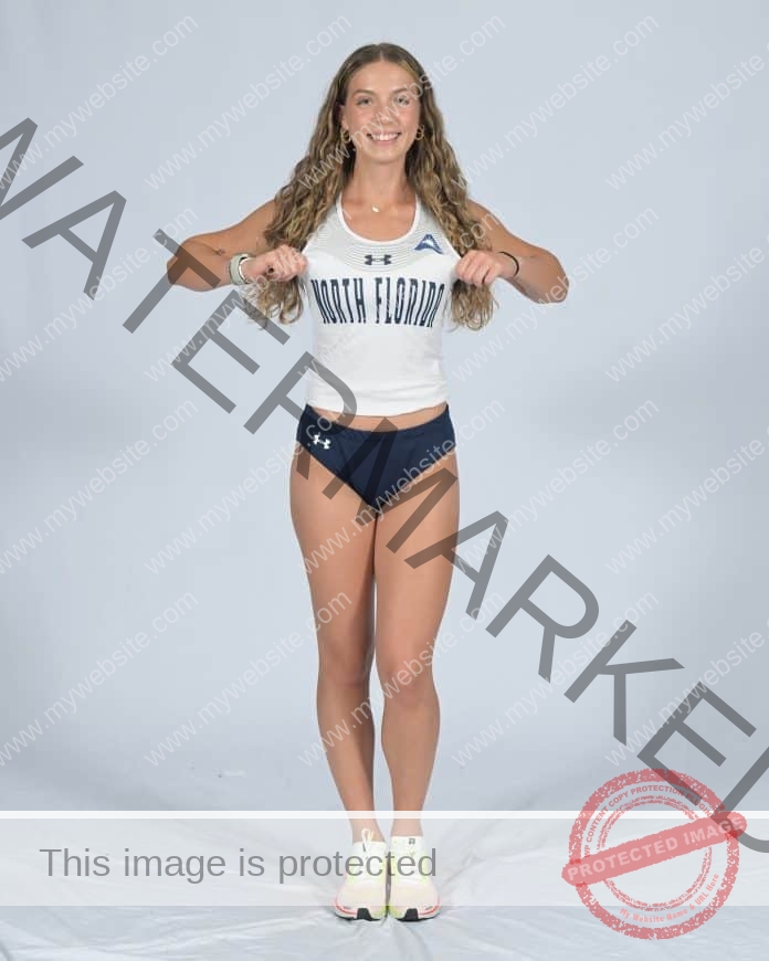 Aleks Futschek posing for her media photos in her North Florida track uniform.