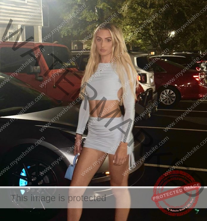 Ella Rush wearing a clingy white club outfit