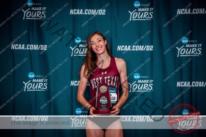 Miriam Zanovello posing for an award in her West Texas track and field uniform.