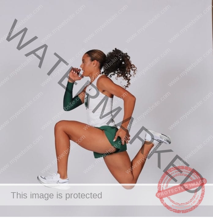 Alexis Brown in a mid-air pose for her media photos in her Baylor track and field uniform
