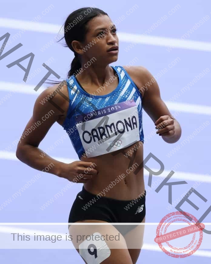 Maria Alejandra Carmona on the track wearing her track uniform and name plate.