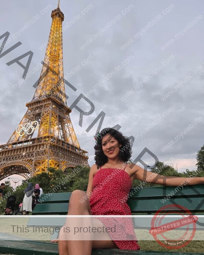Mexican runner Alma Cortes sitting in front of the Eiffel Tower