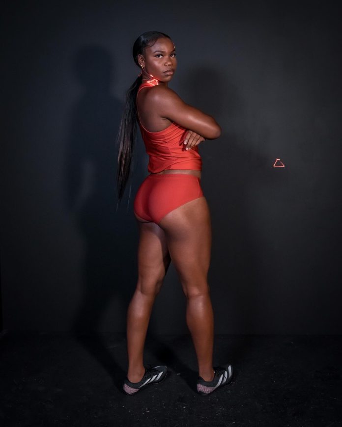 Colleen Uzoekwe, body pointed backward but head turned around facing forward.