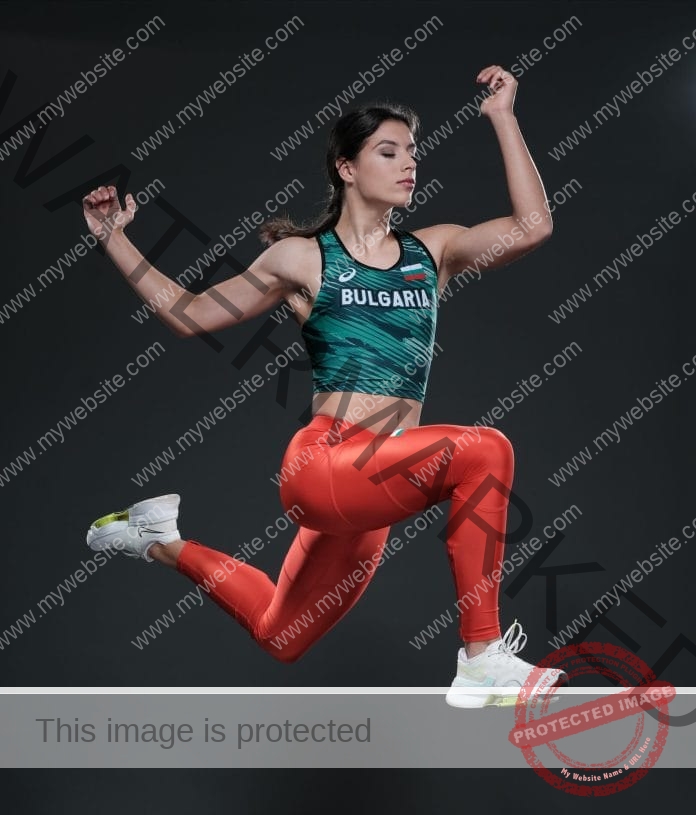 Plamena Mitkova, in her Bulgaria track uniform, caught in a mid-air jump photo