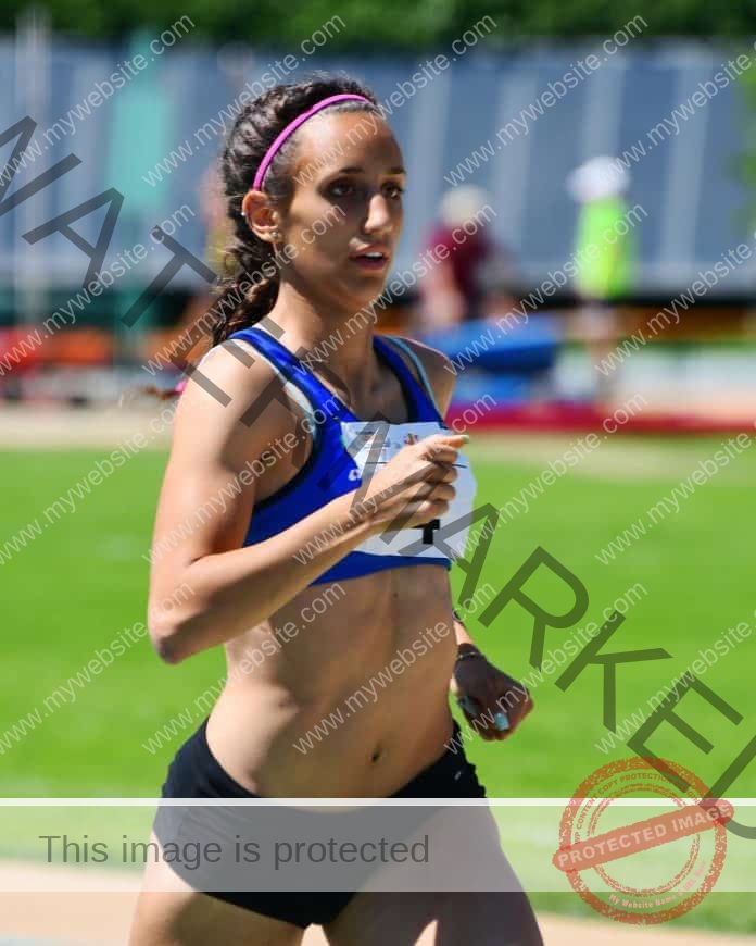 Alice Boasso running in a race at the track, focused look on her face.