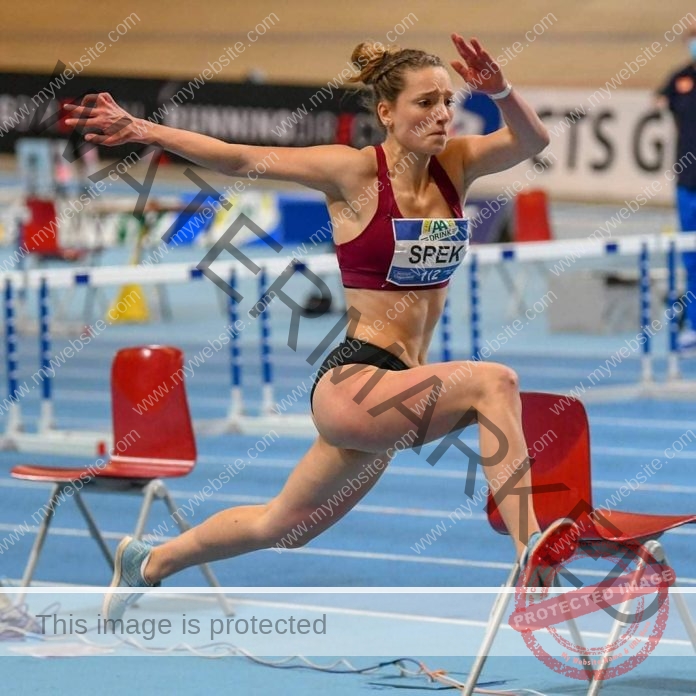 Danielle Spek triple jumping on a blue track