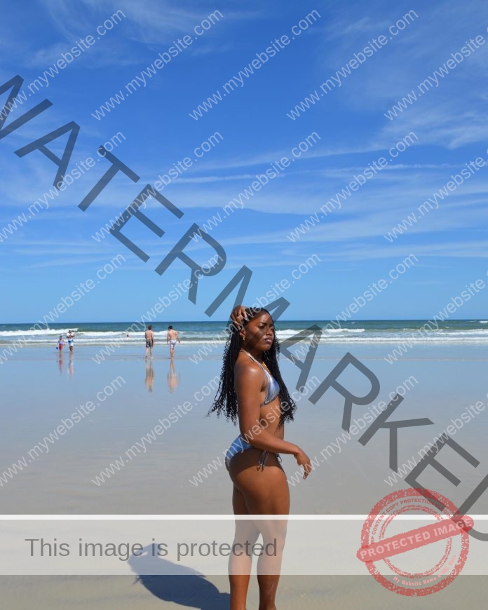 Ronasche Fluker in a purple bikini enjoying a day at the beach.