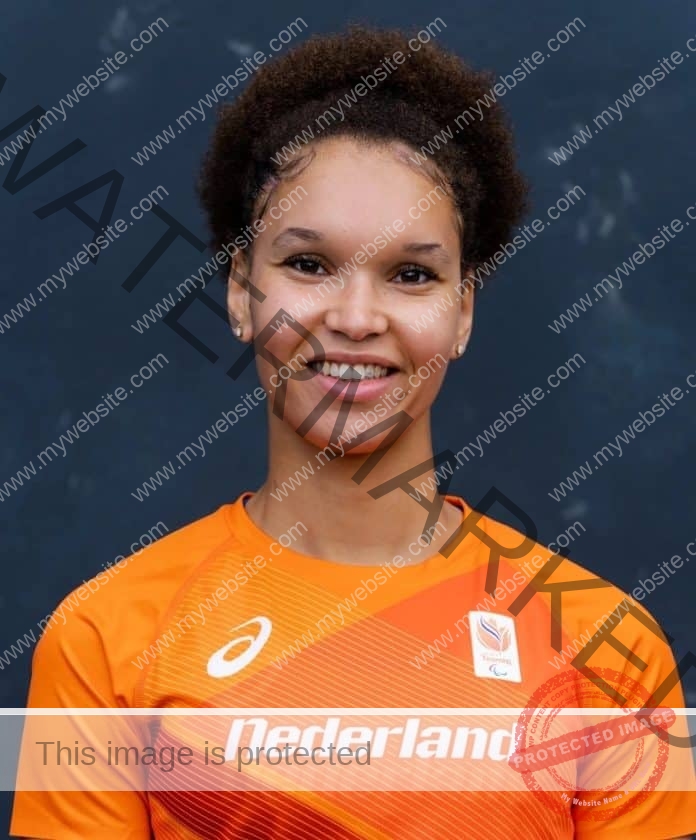 Salima Rozema posing for a picture in her Netherlands track uniform, with a big smile.