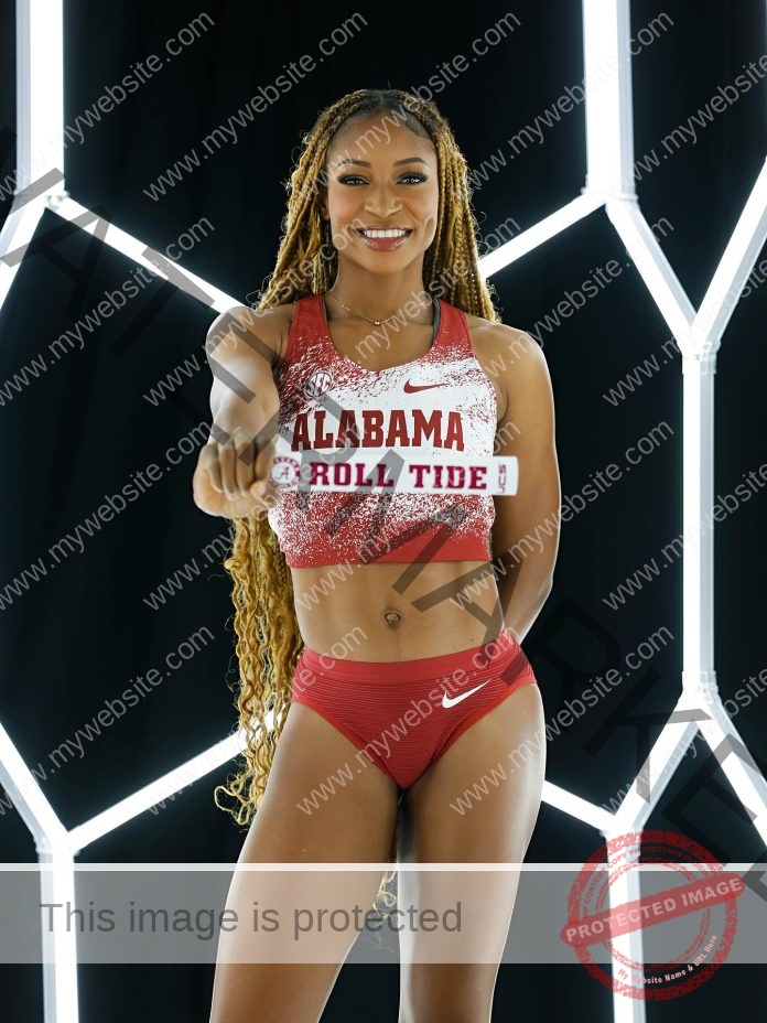 Precious Nzeakor smiles in Alabama Crimson Tide uniform against glowing geometric light backdrop.