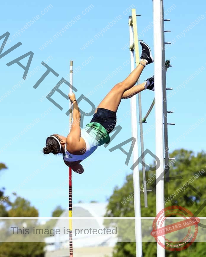Abi Sepulveda clearing a high bar in the pole vault competition