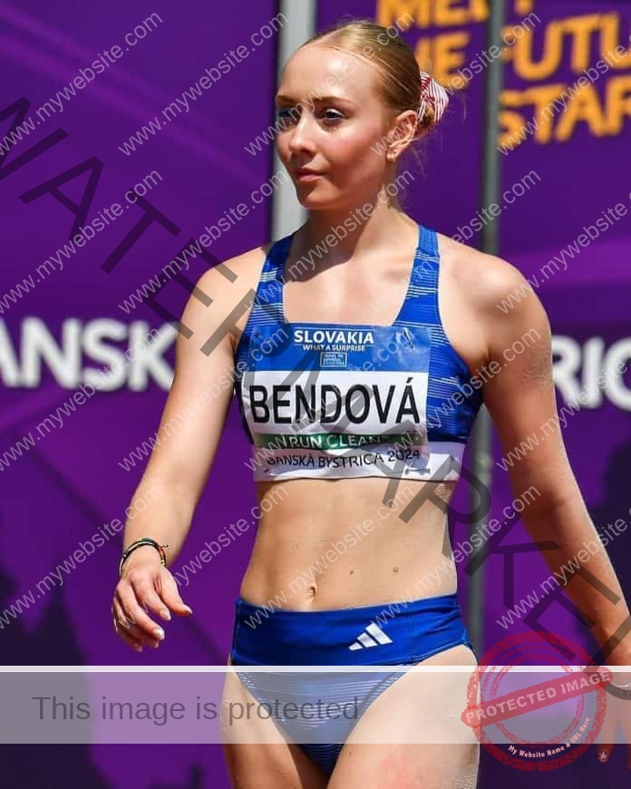 Ema Bendova at the track, name plate on her front, ready to race in her blue track uniform.