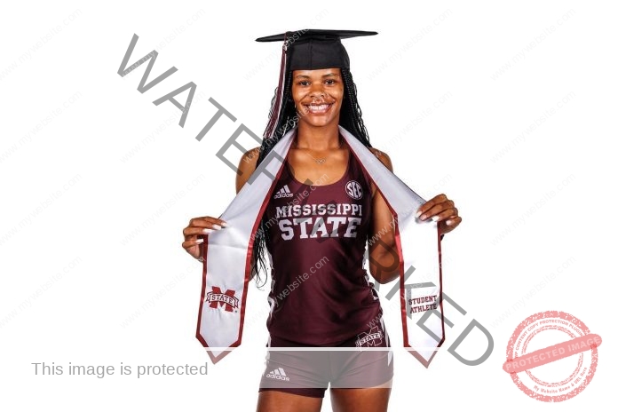 Kennedy Jackson posing for a photo shoot in her Mississippi State track uniform and graduation cap.