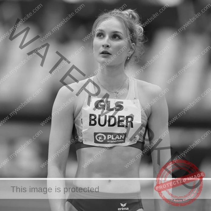 Libby Buder in black and white, wearing her competition track uniform at a race.