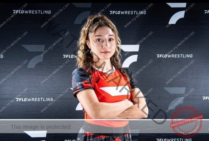 SaVannah Cosme posing for a picture in her fighting kit, arms folded.