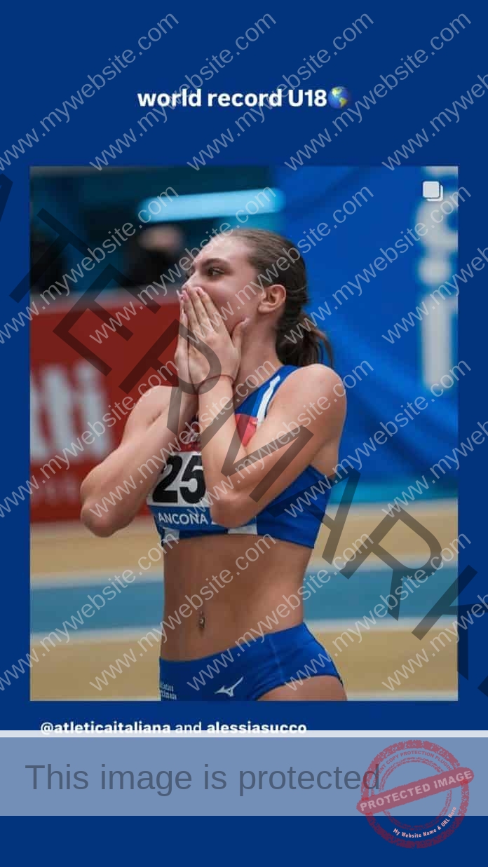Alessia Succo wearing her track uniform with her hands covering her mouth in disbelief as she has just won the race.