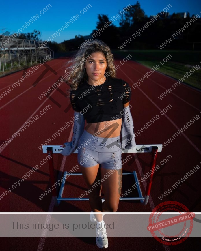 Angie Mesa Espinosa flexing in athletic wear, displaying her muscular physique and fitness dedication.