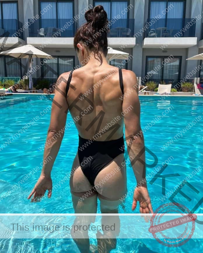 Anna Giannadaki steps into the pool in a black swimsuit