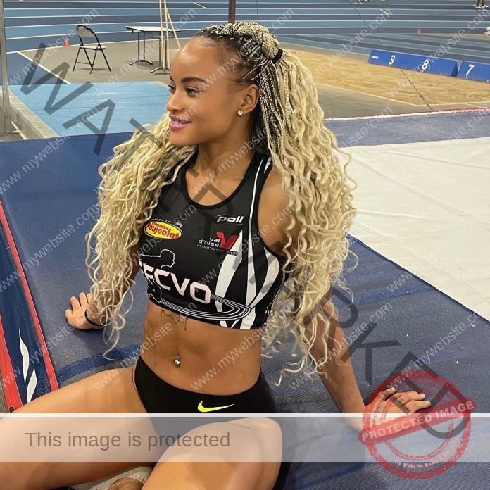 Fatoumata Diallo relaxes on an indoor track, showcasing athletic strength and confidence.