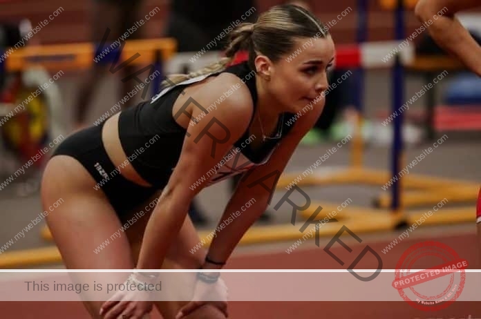 Iva Deliverska of Bulgaria standing on the track and resting with her hands on her knees after running a race.