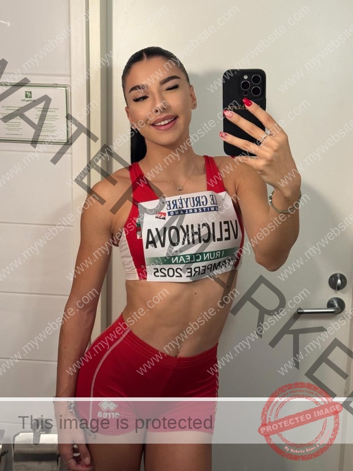 Radina Velichkova in red and white track gear takes a mirror selfie, race bib reading Radina Velichkova, RUN TEAM, EMPIRE 2023.