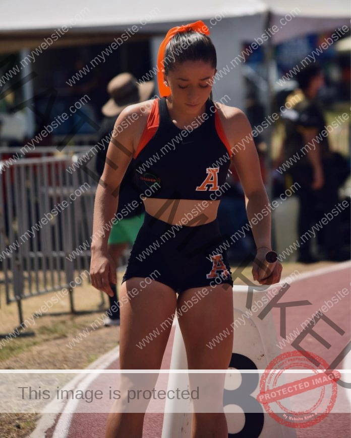 Sofia Mackinney preparing for her race on the track in Mexico, wearing a black athletic uniform.