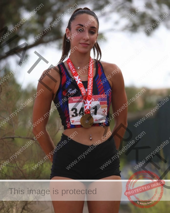 Maltese athlete Zaida Pace poses confidently in athletic wear with hands on hips.