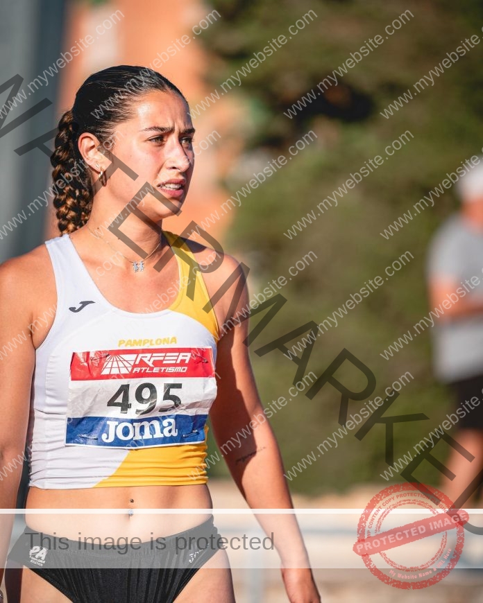 Iratxe Sarasola in her track uniform on the track, looking determined before a race.