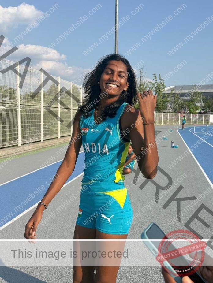 Abinaya Rajarajan celebrating on track in turquoise India uniform after athletic victory.