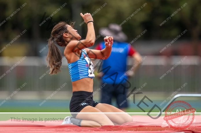 Chung Wai Yan celebrates a victorious high jump moment with joy at a track and field event.