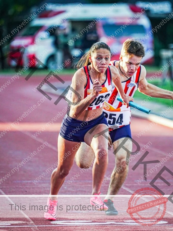 Daisy Camila Llanes Franco sprints on red track during Paraguay relay race.