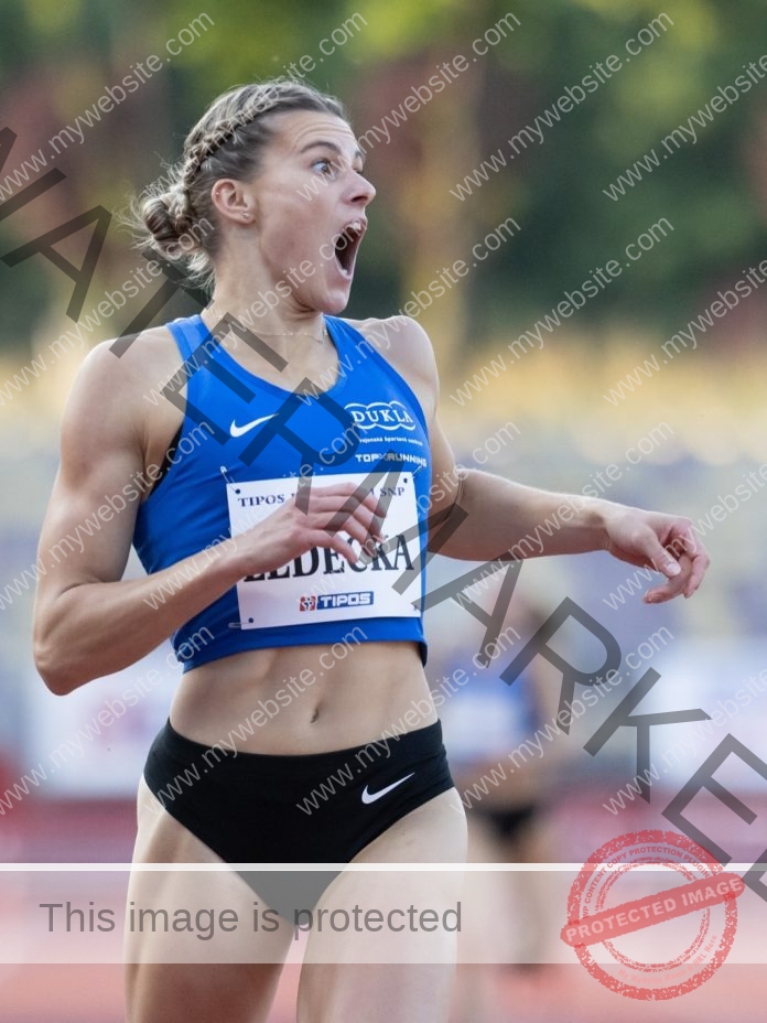 Daniela Ledecka sprinting on a red track, showing determination and athletic power.