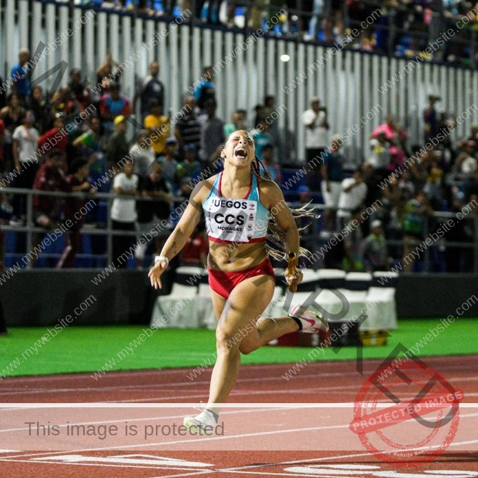 Eidymar Barrios of Venezuela sprinting with determination on a red track before cheering fans.