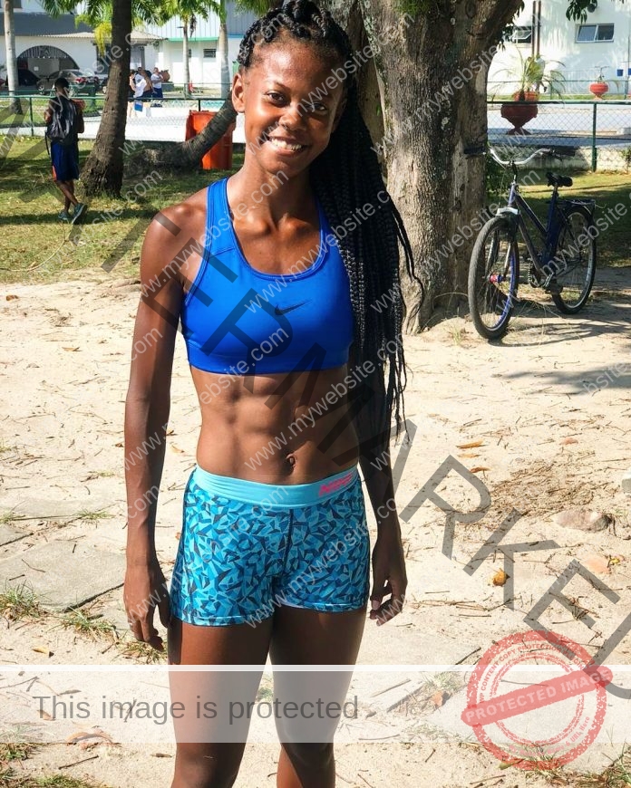 Gabriela Mourão smiling outdoors in blue sportswear, showcasing fitness and active lifestyle energy.