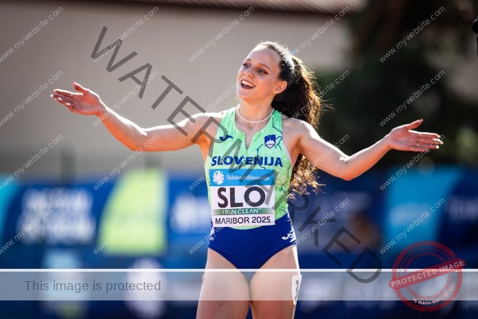 Lucjia Potnik waves at the crows in her Slovenian national team single of green and blue.
