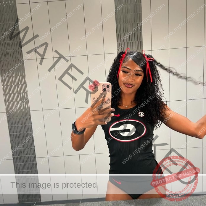 Trinidad and Tobago athlete Sanaa Frederick poses confidently, displaying her muscular physique and athletic strength.