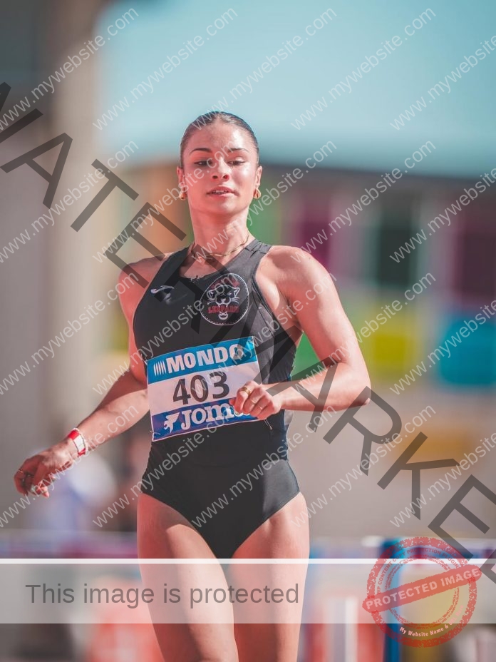 Track athlete in black swimsuit with number 403 competing at stadium event.
