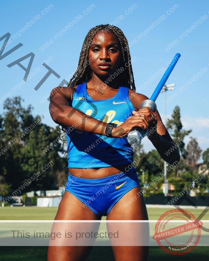 Yani Ndjip Nyemeck, a female athlete in blue UCLA gear, holds a baton on grass with trees and sky, showing passion and heritage.