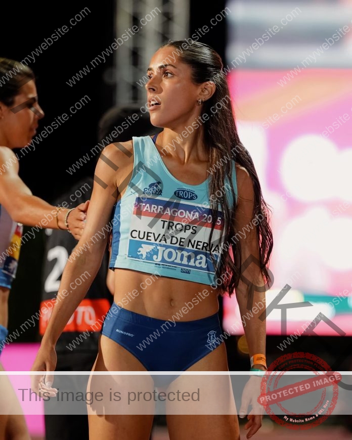 Sara Barba competing in a track and field event wearing a blue uniform.