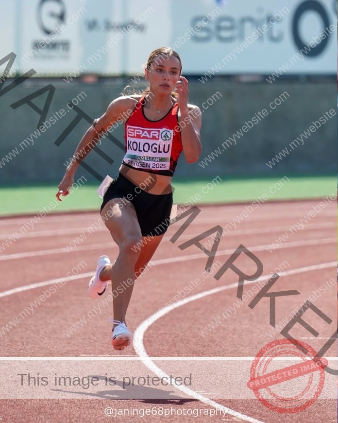 Sıla Koloğlu sprinting on a red track under a clear blue sky during a race.