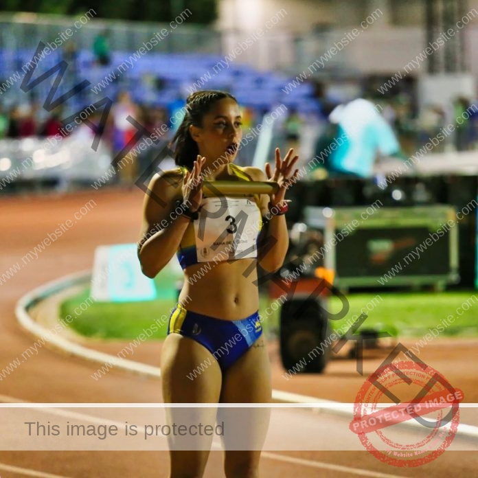 Erika Lopez preparing for race on track wearing competition uniform with number 4.