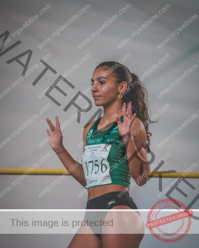 Julia Garcia running in a track competition wearing a green athletic bib.