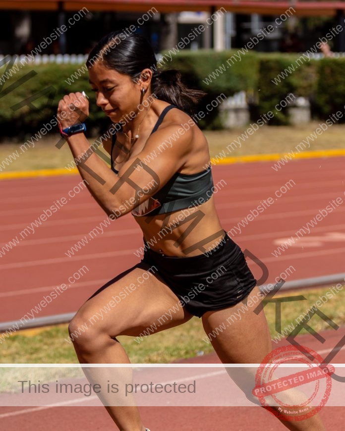 Sarahi Vazquez sprinting on a red track in athletic sports attire.