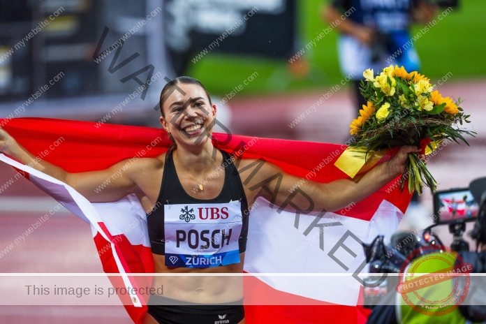 Isabel Posch A smiling track and field athlete from Austria, celebrates on the track with yellow flowers, a red-and-white flag, and race bib.